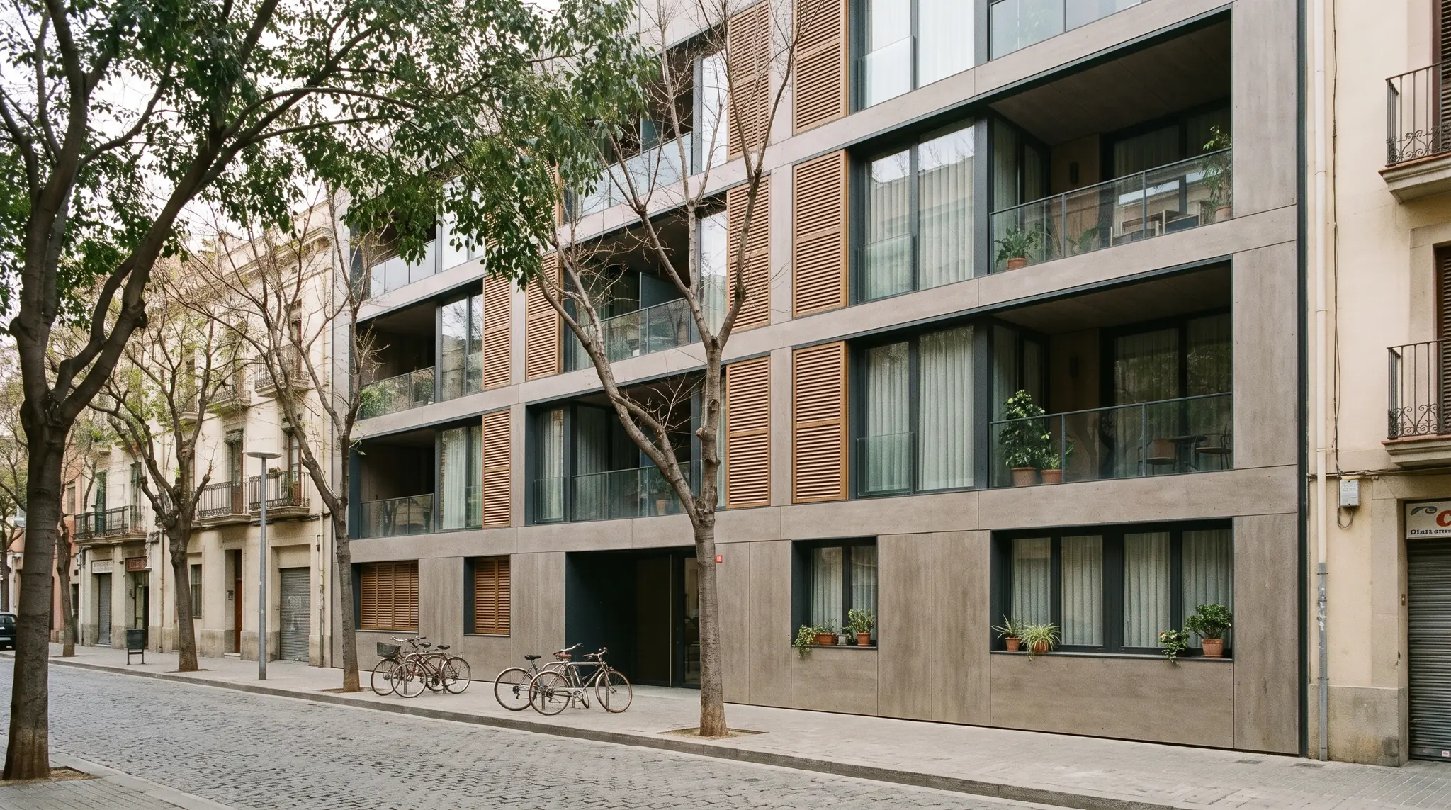 Edifici d'habitatges acabat i habitat en un carrer arbrat